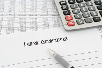lease agreement with numbers, calculator and pen